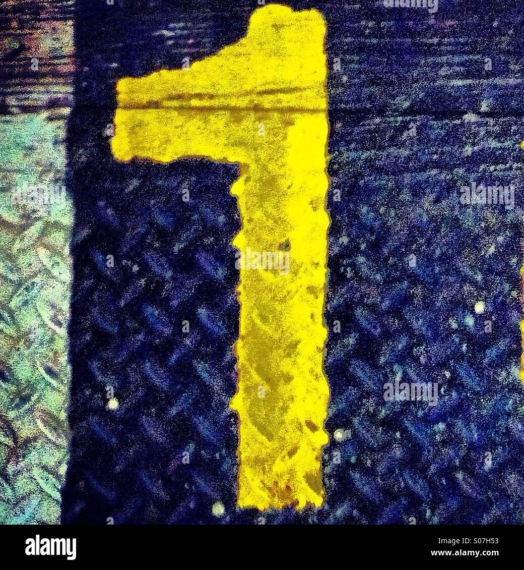 Yellow number 1 painted on the ground - Smartphone Captured Stock Image