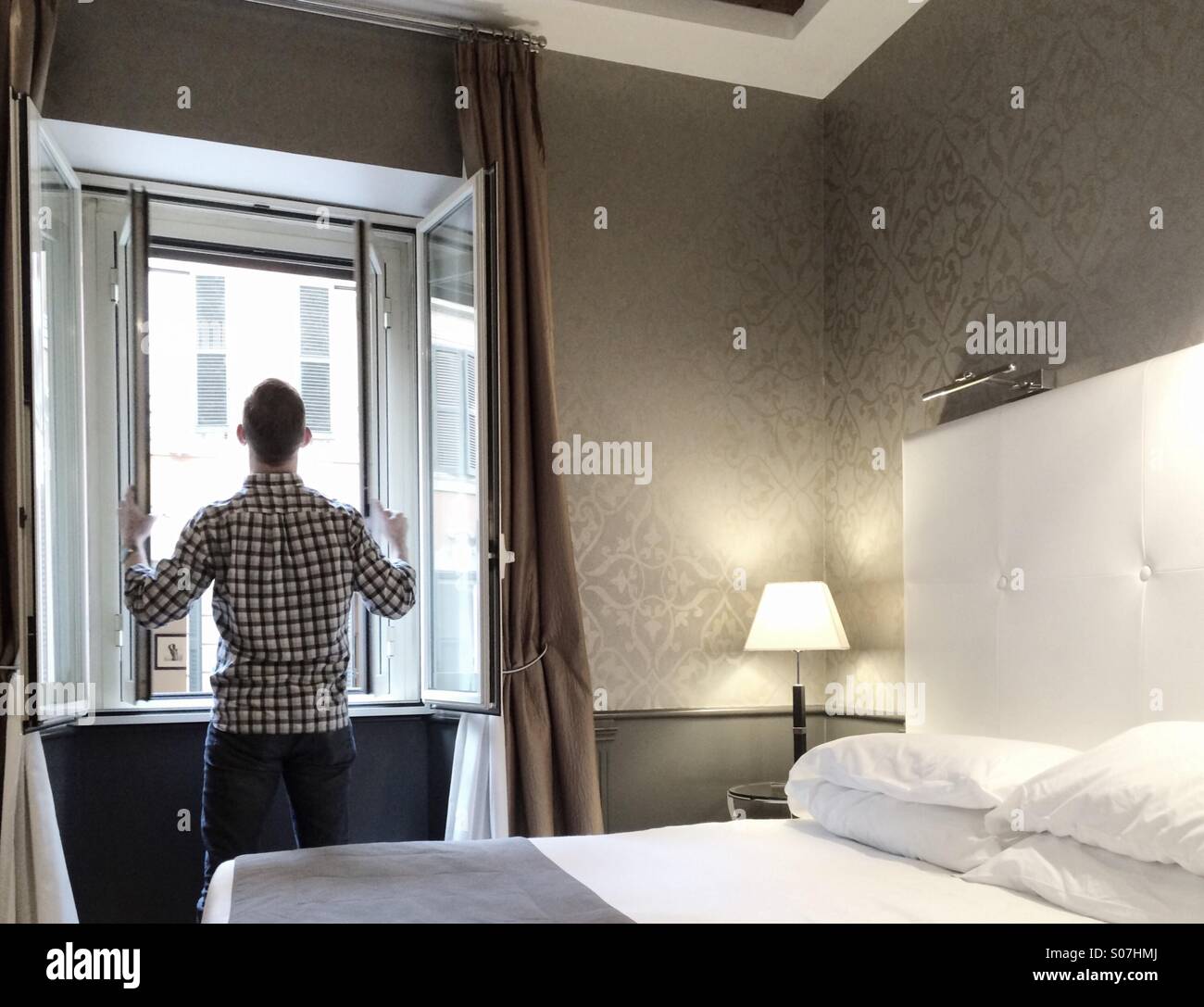 Man in hotel in Rome, Monti Neighborhood - Smartphone Captured Stock Image