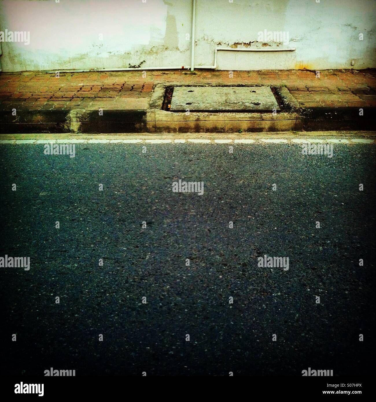 Sewe along the road in a street - Smartphone Captured Stock Image