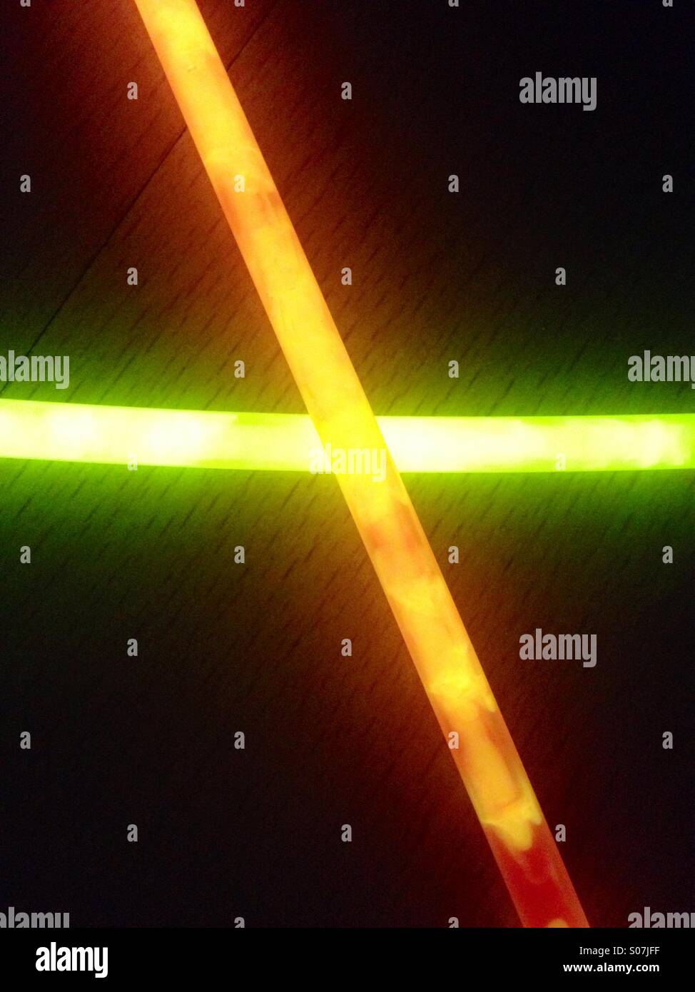 Glow sticks in the shape of an x - Smartphone Captured Stock Image
