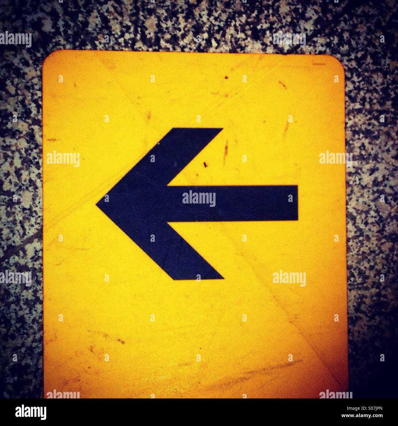 Floor sticker with black arrow showing turn left - Smartphone Captured Stock Image