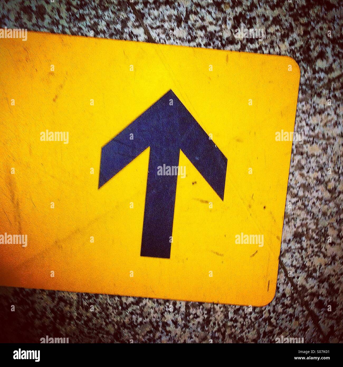 Floor sticker showing black arrow telling going straight or up - Smartphone Captured Stock Image