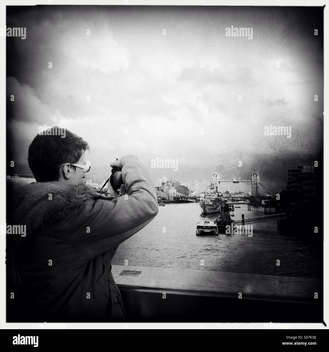 Tourist taking picture of london skyline and tower bridge - Smartphone Captured Stock Image