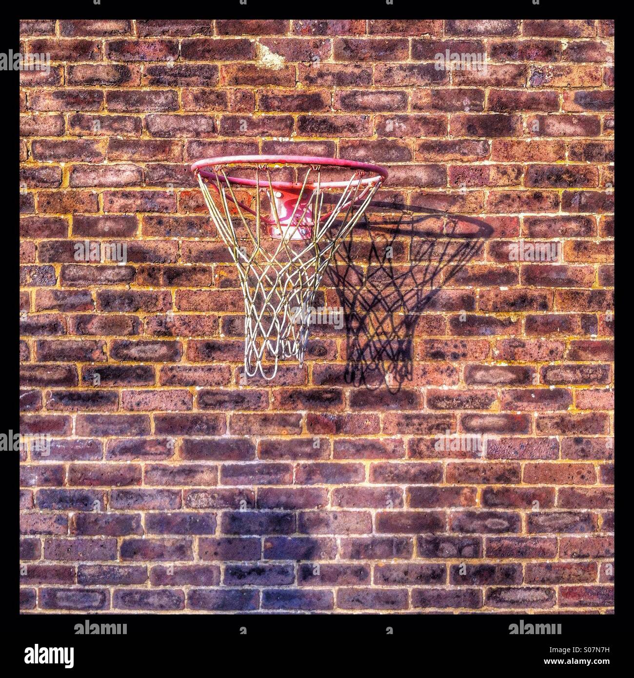 Netball net mounted on a brick wall Stock Photo