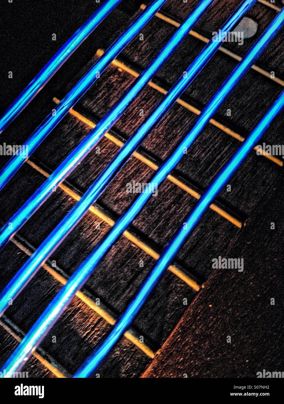 Electro luminescent wire replacing guitar strings on a guitar - Smartphone Captured Stock Image