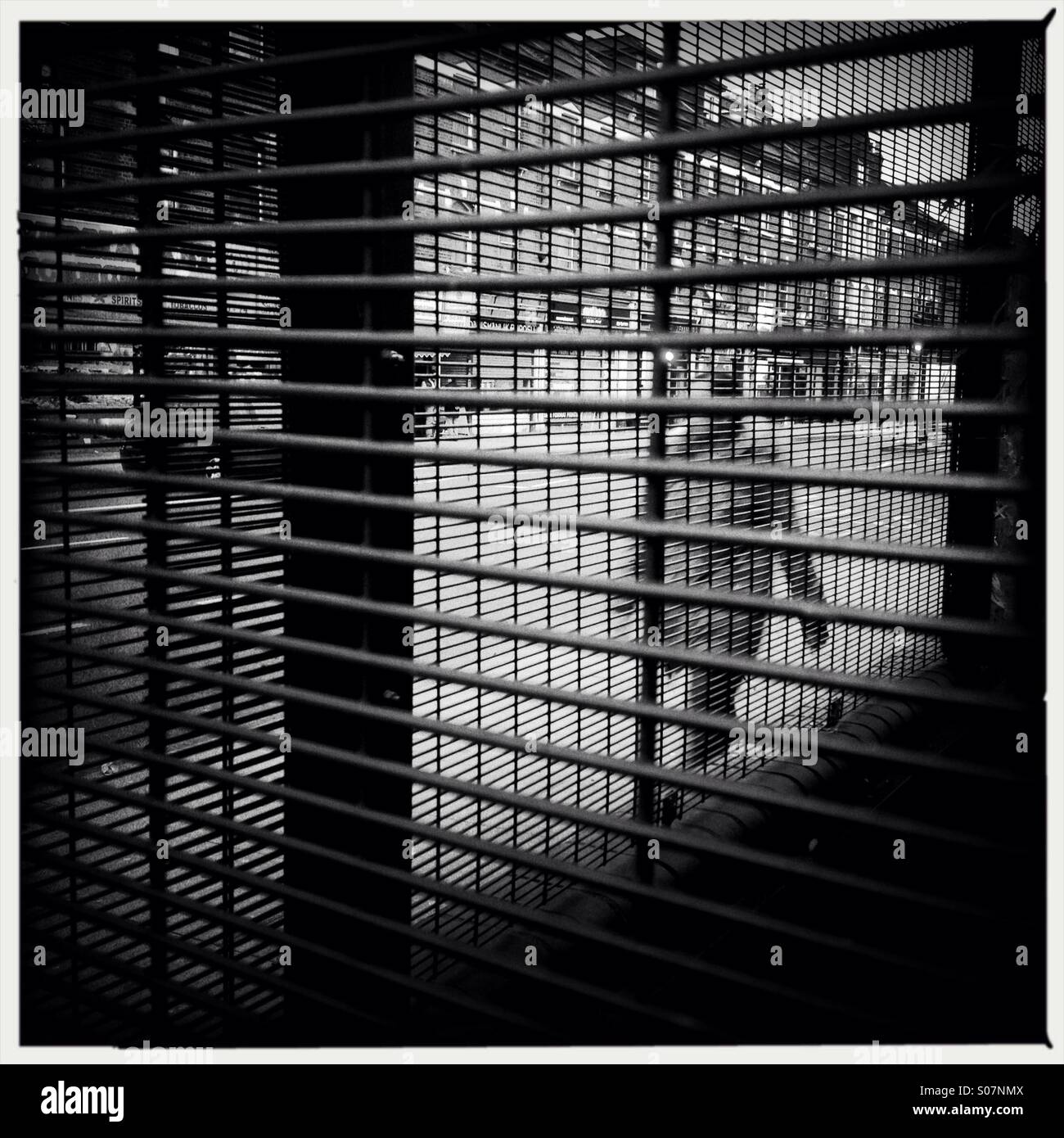 Person walking behind the bars on a east London street - Smartphone Captured Stock Image