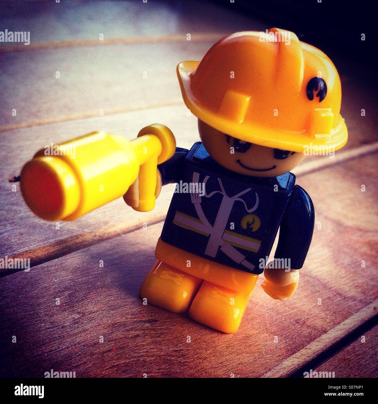 Yellow fireman toy in plastic - Smartphone Captured Stock Image