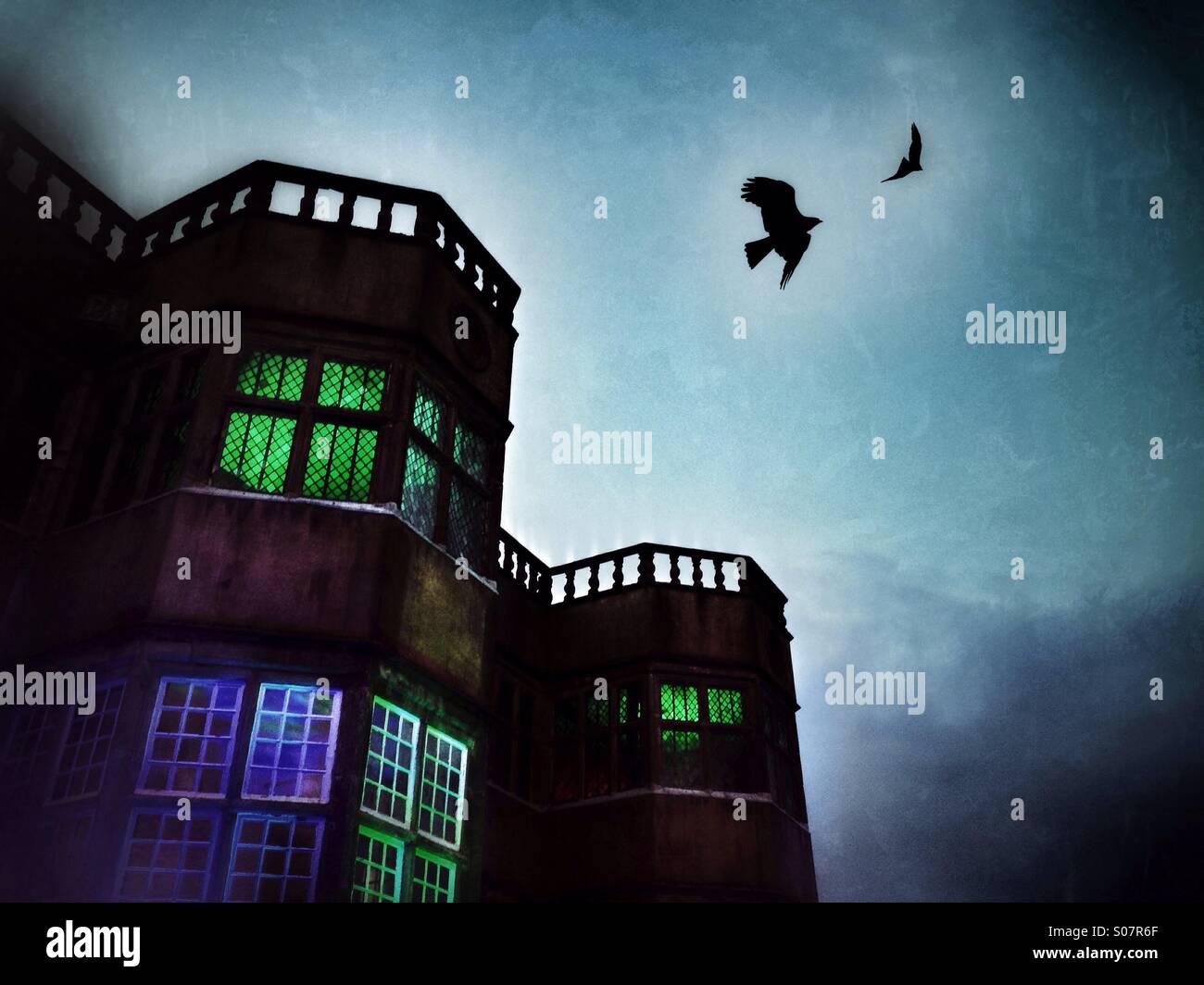 Birds of prey flying above illuminated gothic like building (composite) - Smartphone Captured Stock Image Birds of prey flying above illuminated gothic like building (composite) - Smartphone Captured Stock Image