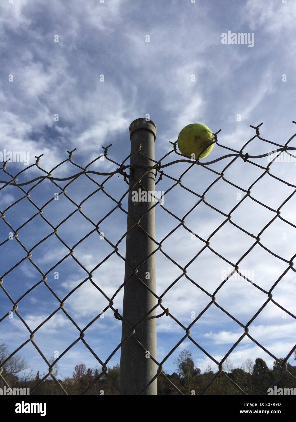 Tennis ball stuck in chain link fence Stock Photo Alamy