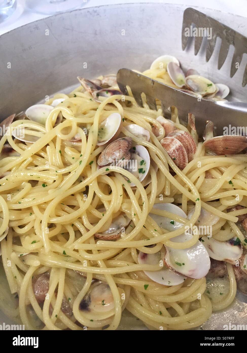 Spaghetti allo scoglio in bianco,noodles white seafood at lunch time,Italy - Smartphone Captured Stock Image