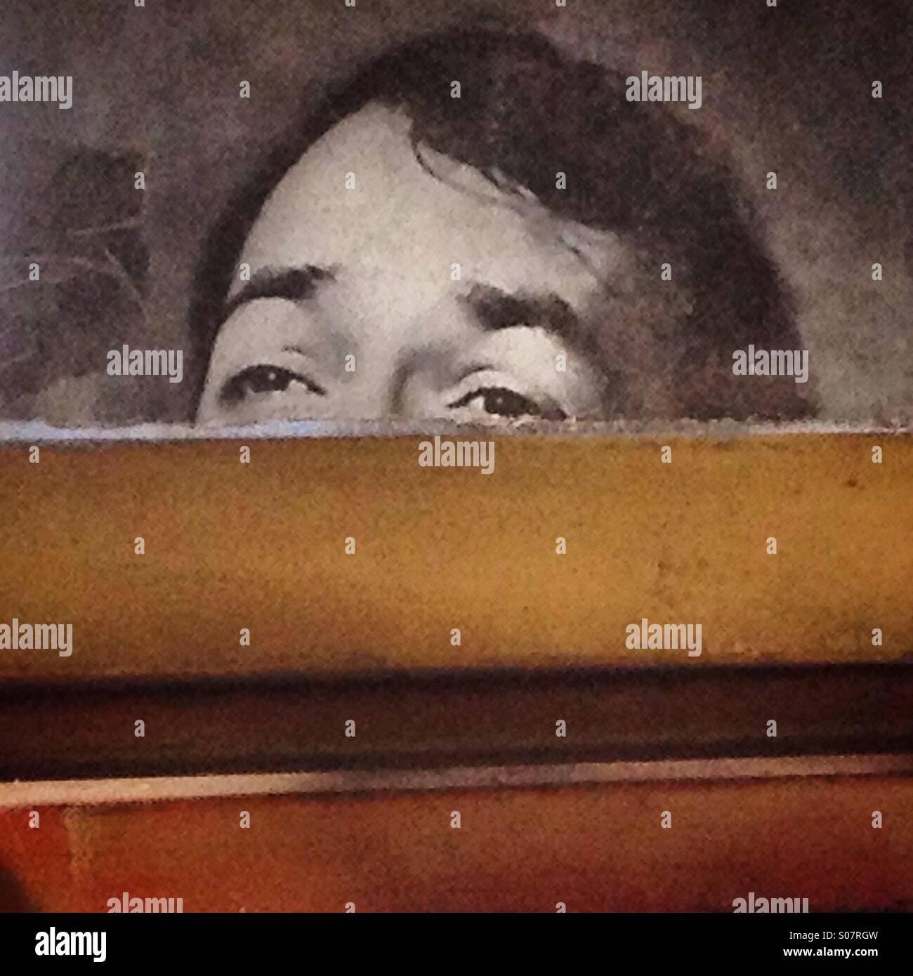 A portrait of a man looking behind a wall decorates an altar in Colonia Roma, Mexico City,Mexico - Smartphone Captured Stock Image