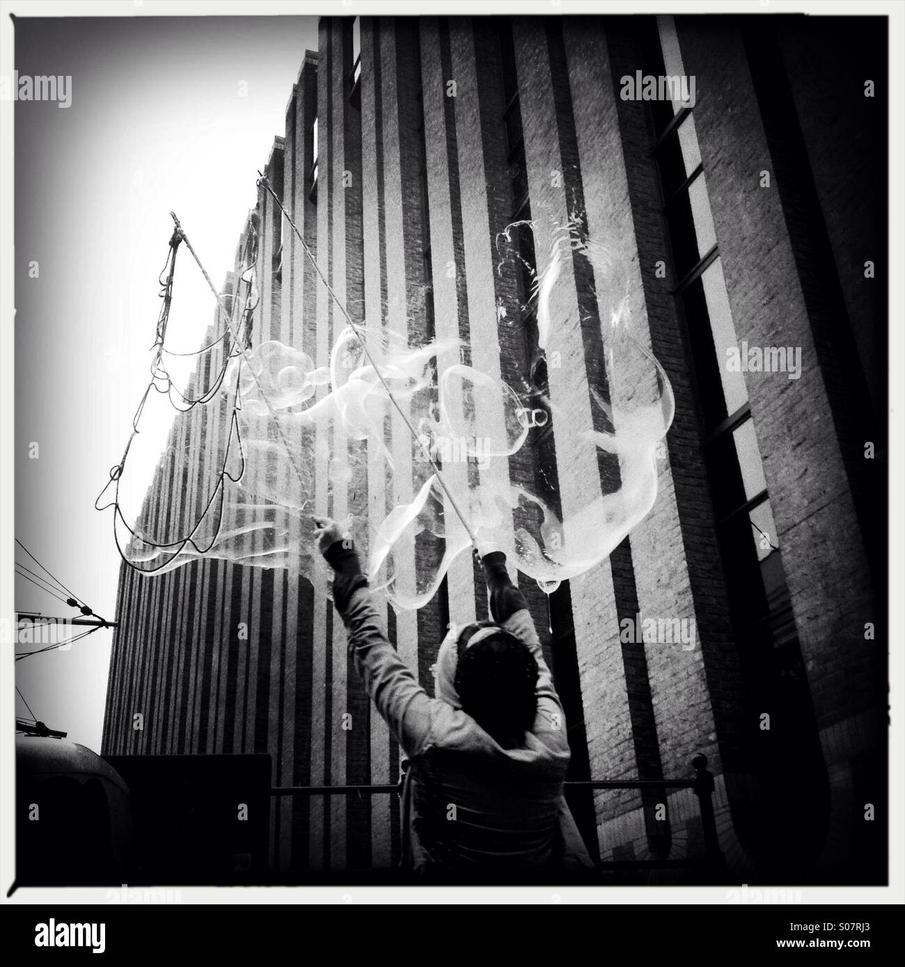 Street artist blowing bubbles in southbank London - Smartphone Captured Stock Image