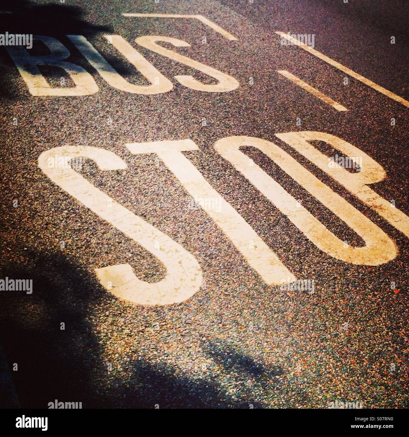 Bus stop written on the road Stock Photo Alamy