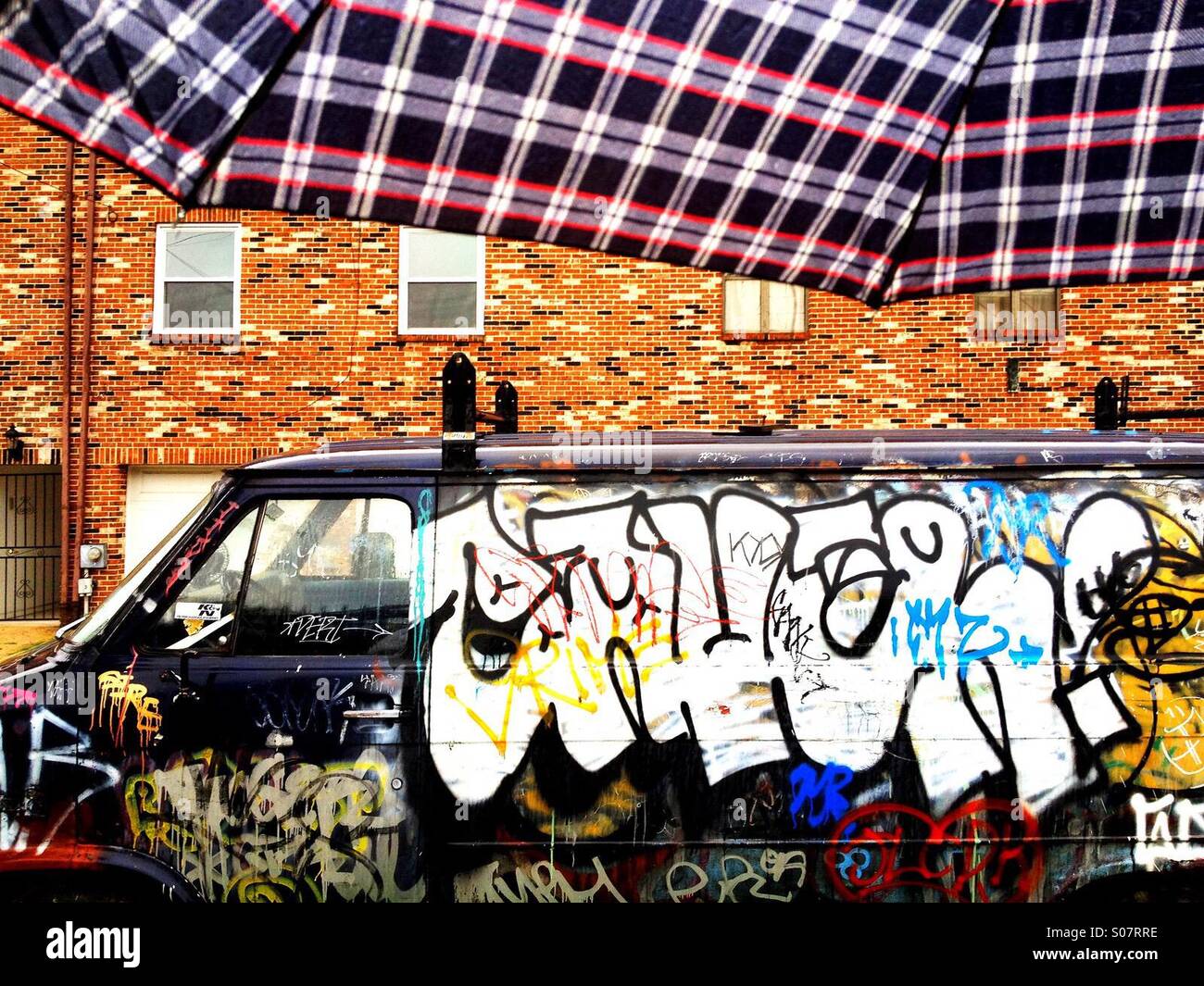 Van with graffiti and umbrella in South Philadelphia, Pennsylvania - Smartphone Captured Stock Image