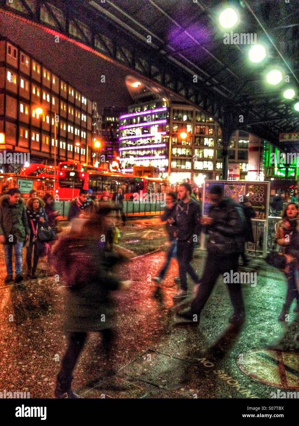 Victoria station commuters at night - Smartphone Captured Stock Image