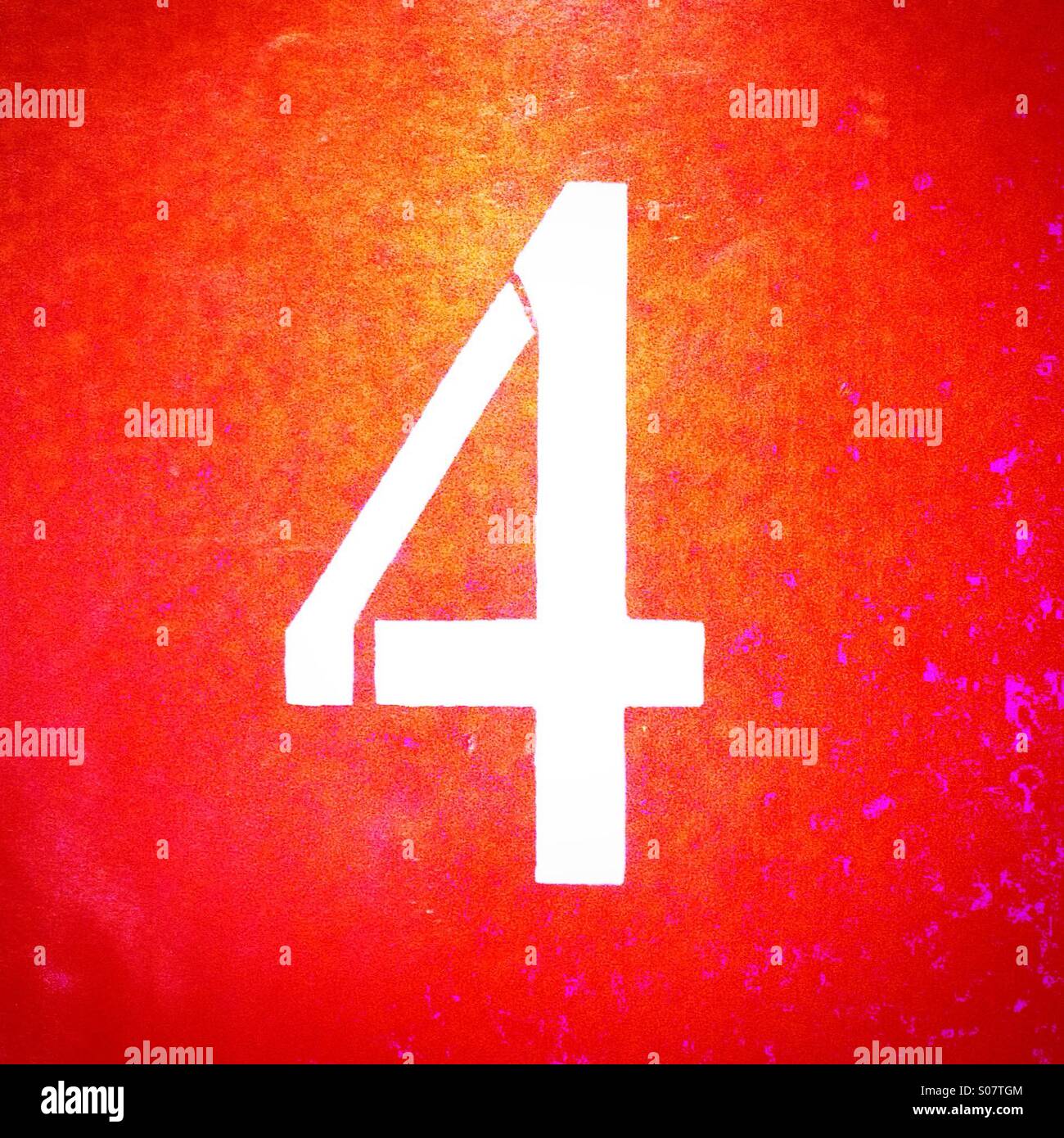 Number 4 painted in white on orange wall - Smartphone Captured Stock Image