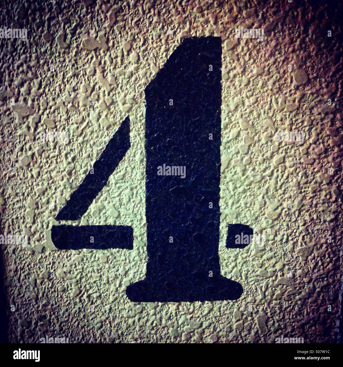 Number 4 stencil painted in black on a textured wall - Smartphone Captured Stock Image