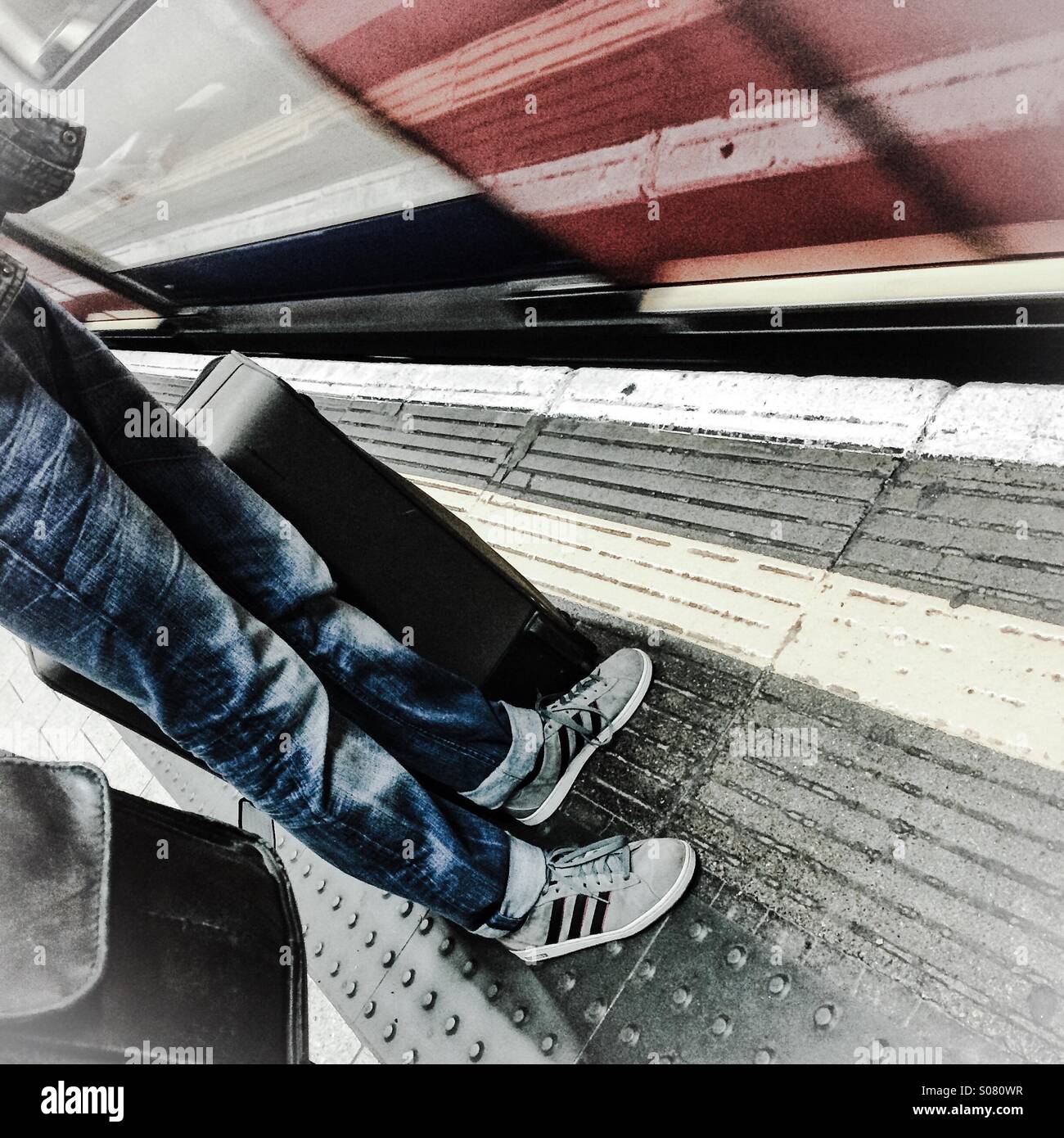 Traveller with luggage waiting to board train - Smartphone Captured Stock Image