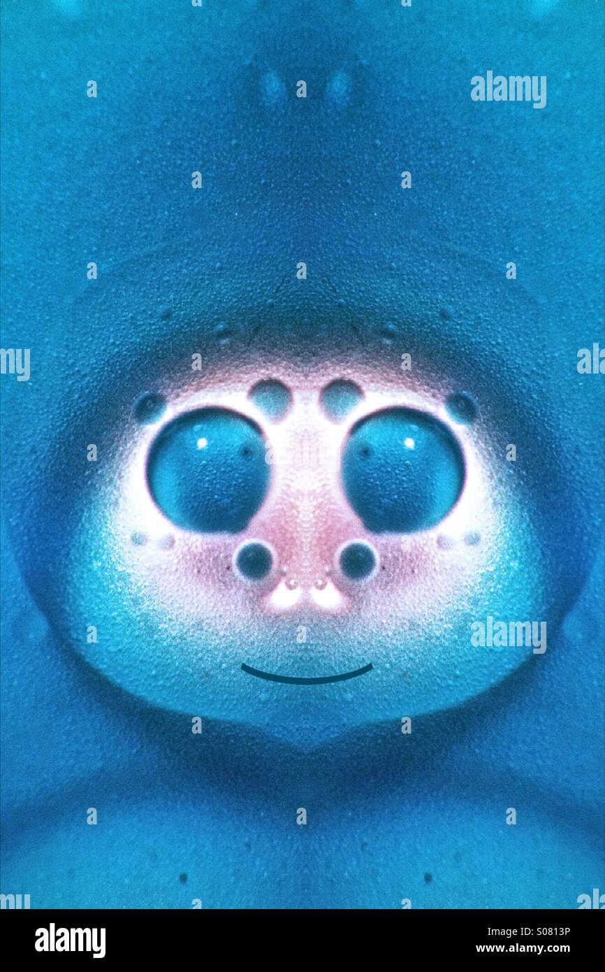 Symmetrical photo of oil and water which looks like a cartoon character - Smartphone Captured Stock Image