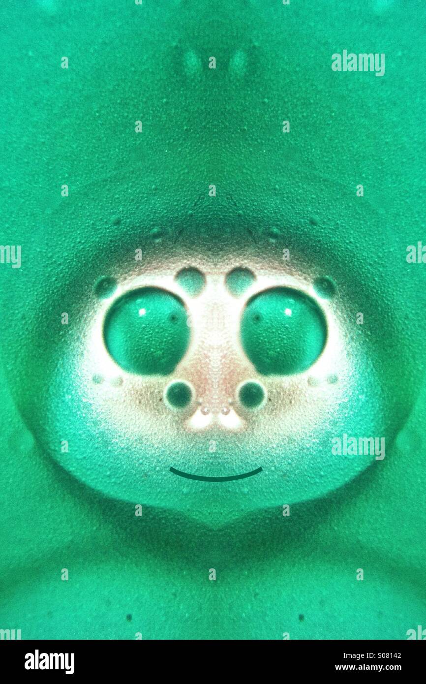 Symmetrical photo of oil and water which looks like a cartoon character - Smartphone Captured Stock Image