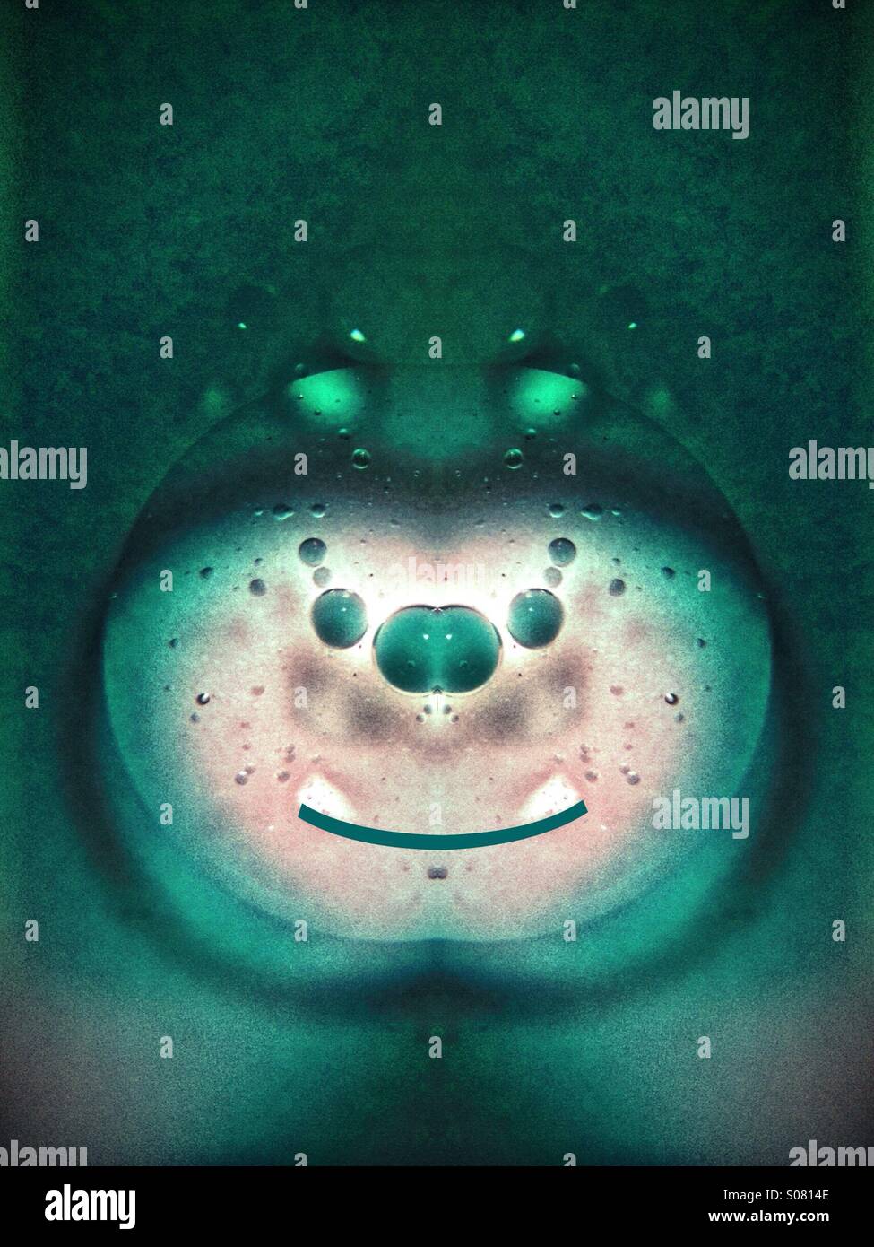 Symmetrical photo of oil and water that looks like a cartoon character - Smartphone Captured Stock Image