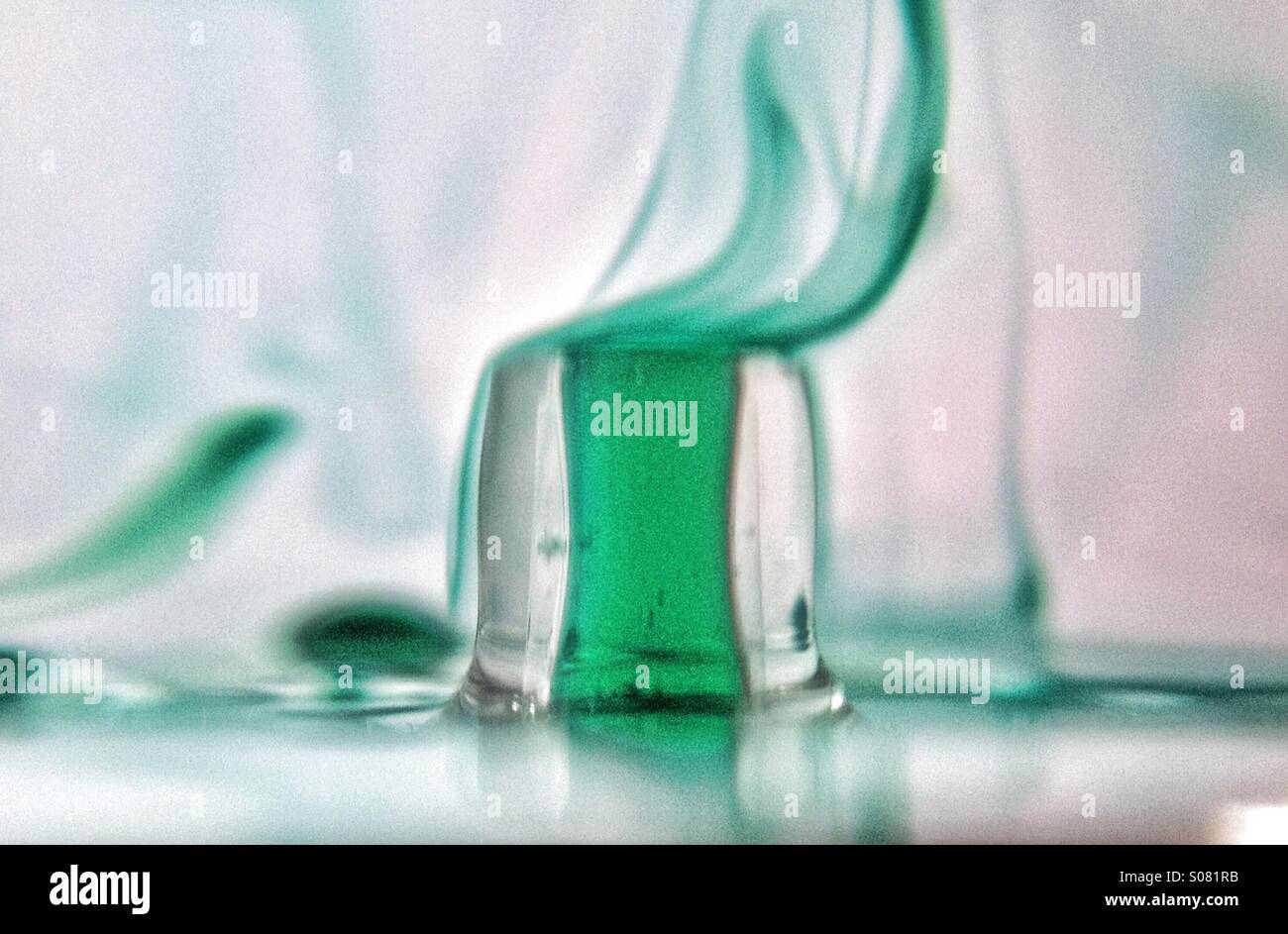 Dropper dropping coloured water into clear water - Smartphone Captured Stock Image