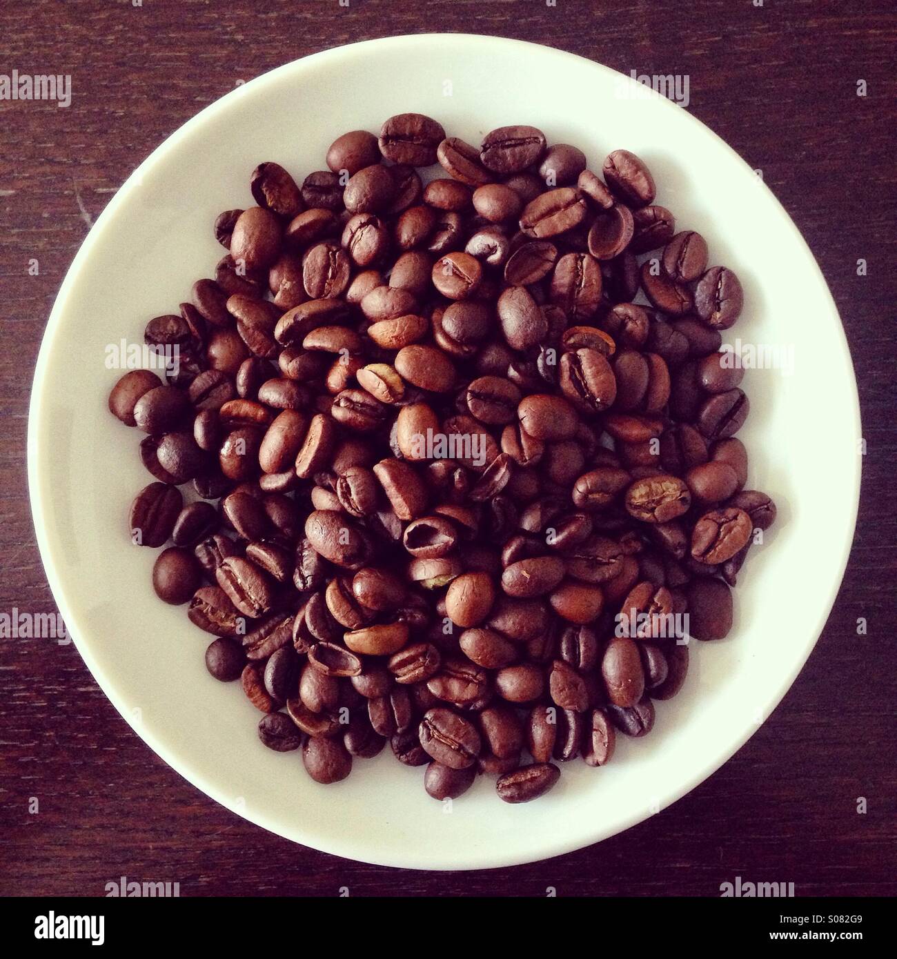Roasted coffee beans on plate Stock Photo