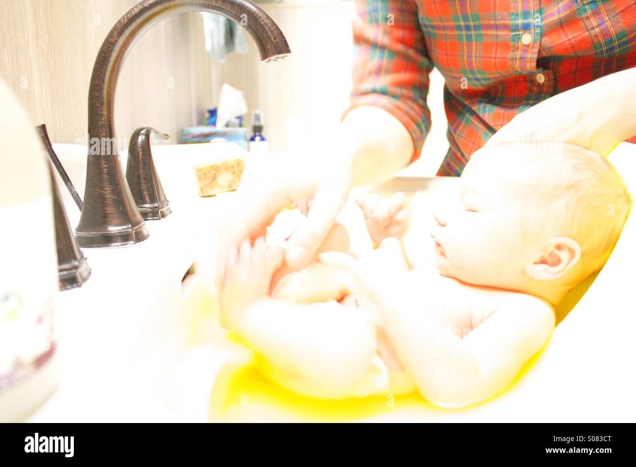 Baby's first bath Stock Photo Alamy