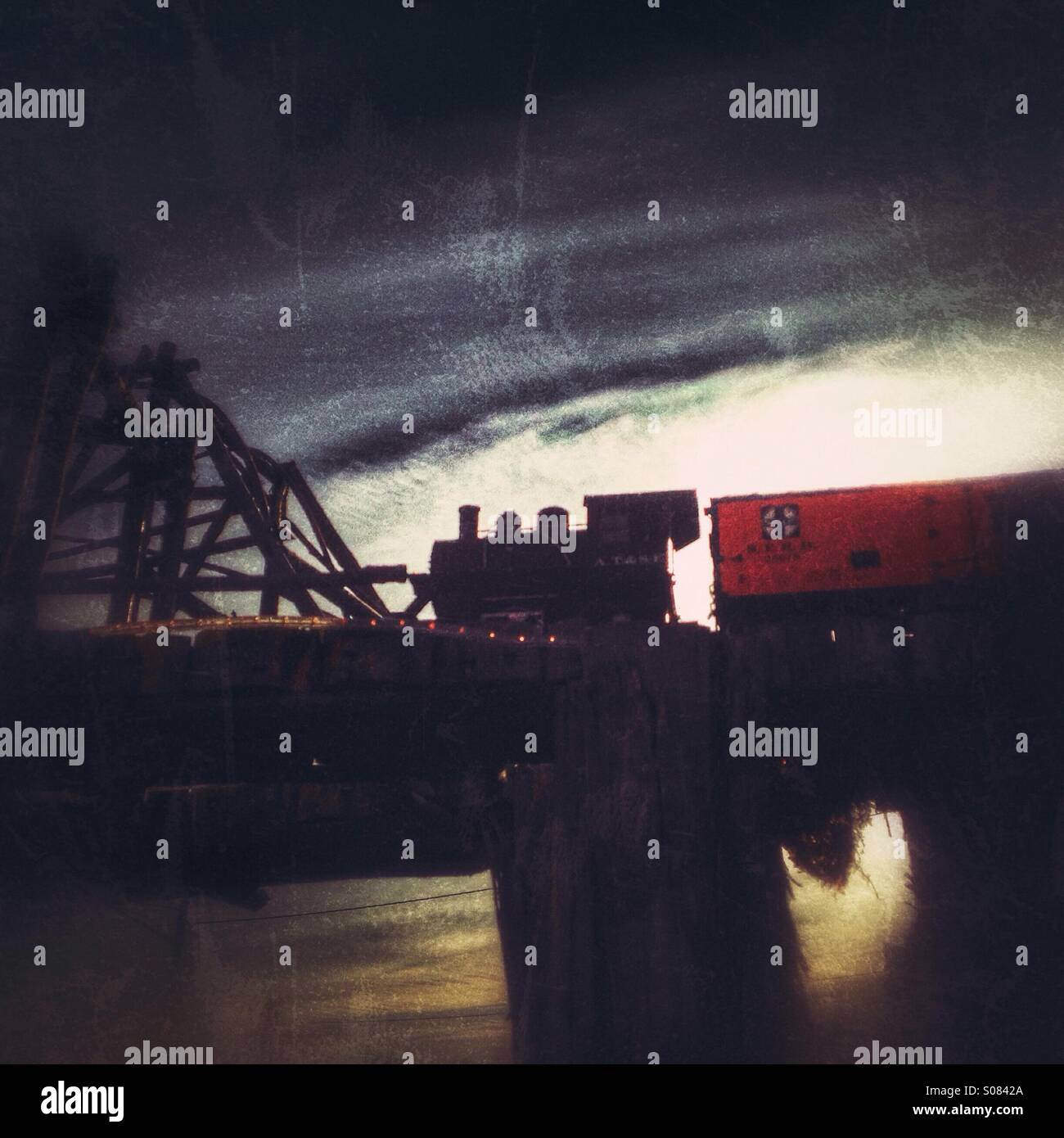 A toy train going over a bridge. - Smartphone Captured Stock Image