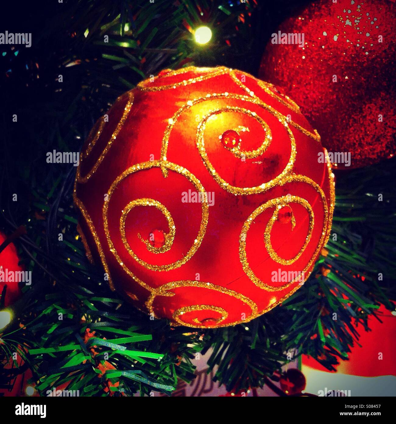 Red christmas ball with golden pattern on it - Smartphone Captured Stock Image