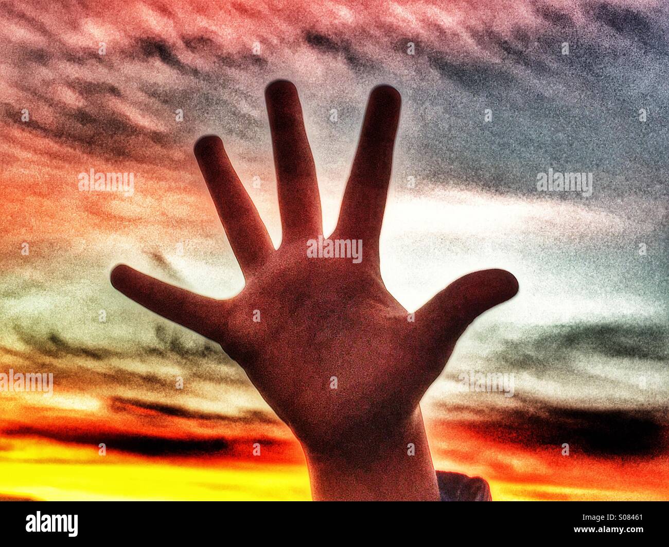 Child's hand against sunset - Smartphone Captured Stock Image