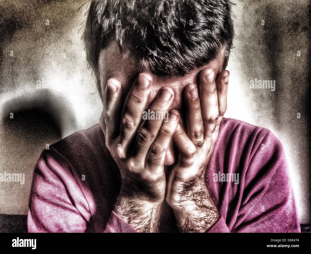 Depressed man head in hands - Smartphone Captured Stock Image