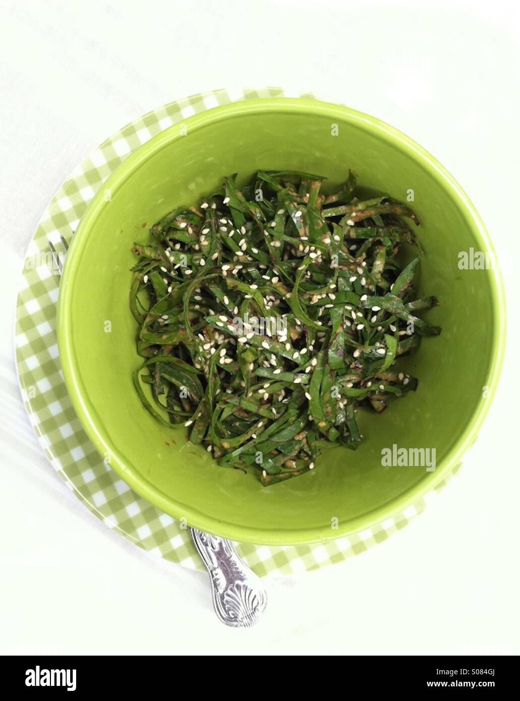 Chopped beet green salad with a spicy peanutsesame dressing Stock