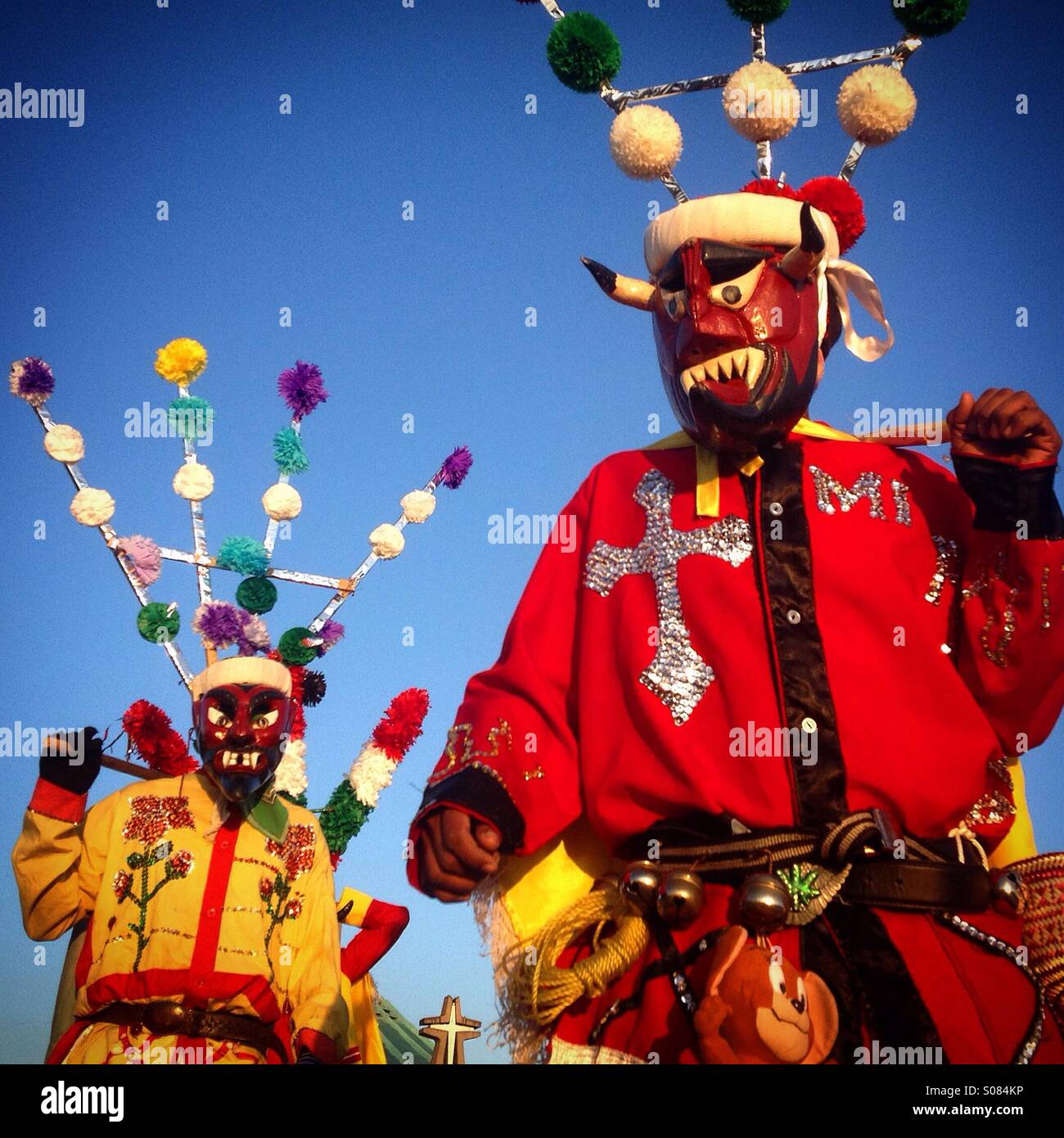 Masked devils from Chocaman, Veracruz, Mexico, perform Saint James Apostle dance at the pilgrimage to the Our Lady of Guadalupe Basilica. The dance represents the victory of the apostle over the Devil - Smartphone Captured Stock Image