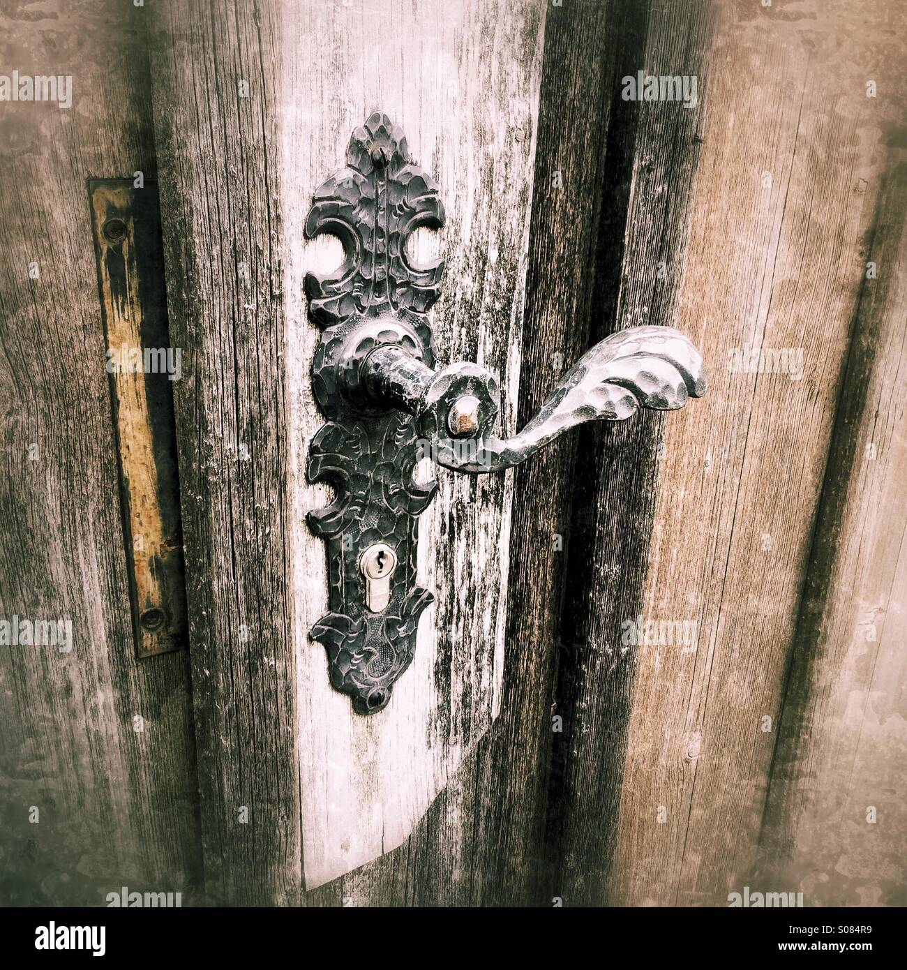 Old brass door handle on rustic wooden door Stock Photo Alamy
