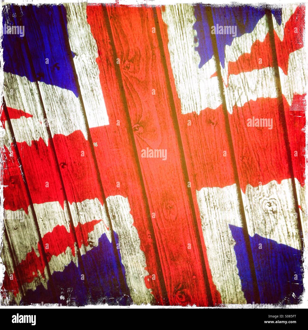 A roughly painted Union Jack flag painted on a wooden textured background - Smartphone Captured Stock Image