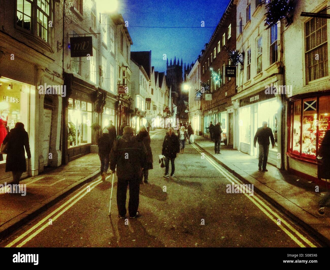 Shoppers at night along Petergate York North Yorkshire England UK - Smartphone Captured Stock Image