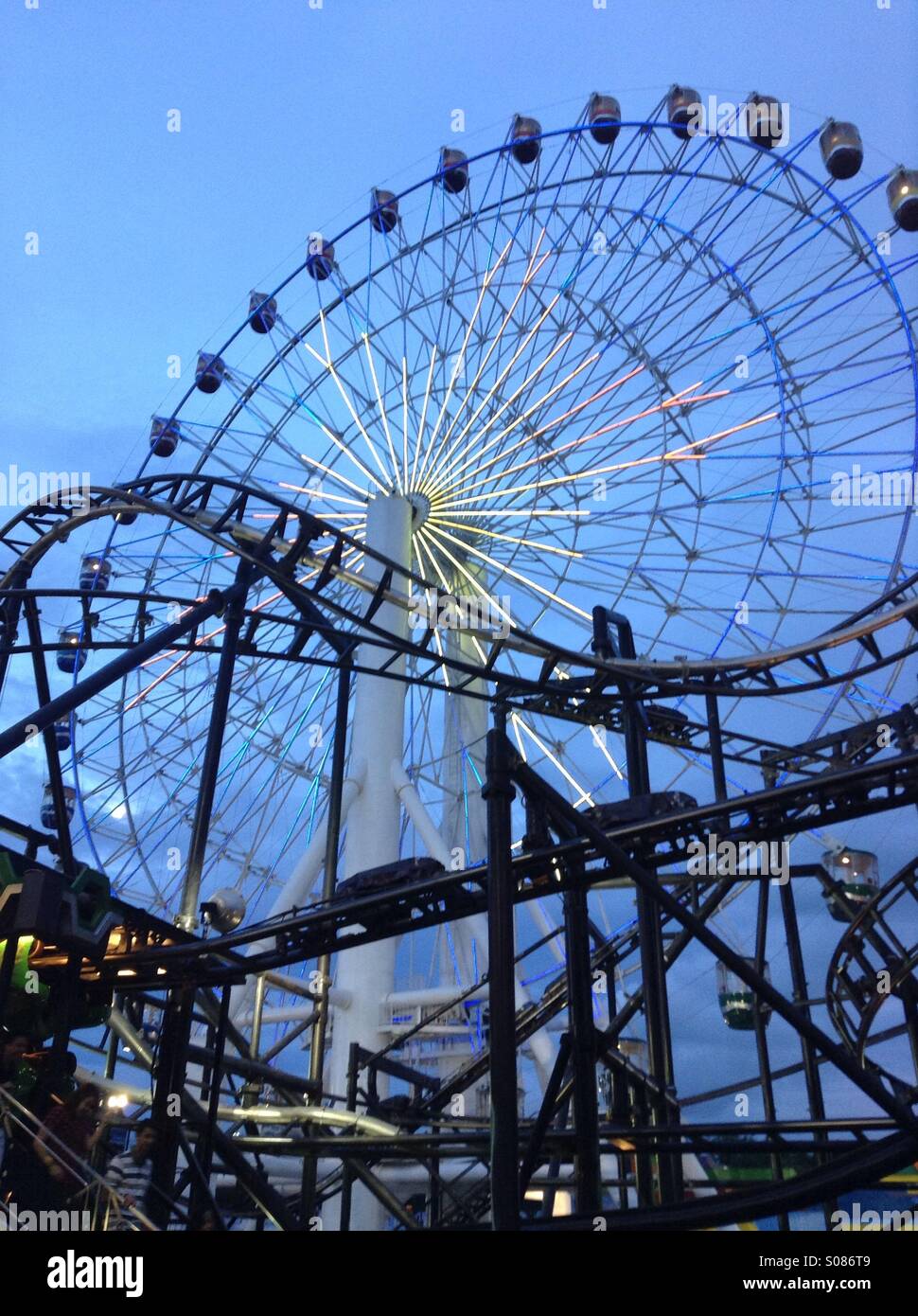 Ferris Wheel with roller coaster Stock Photo