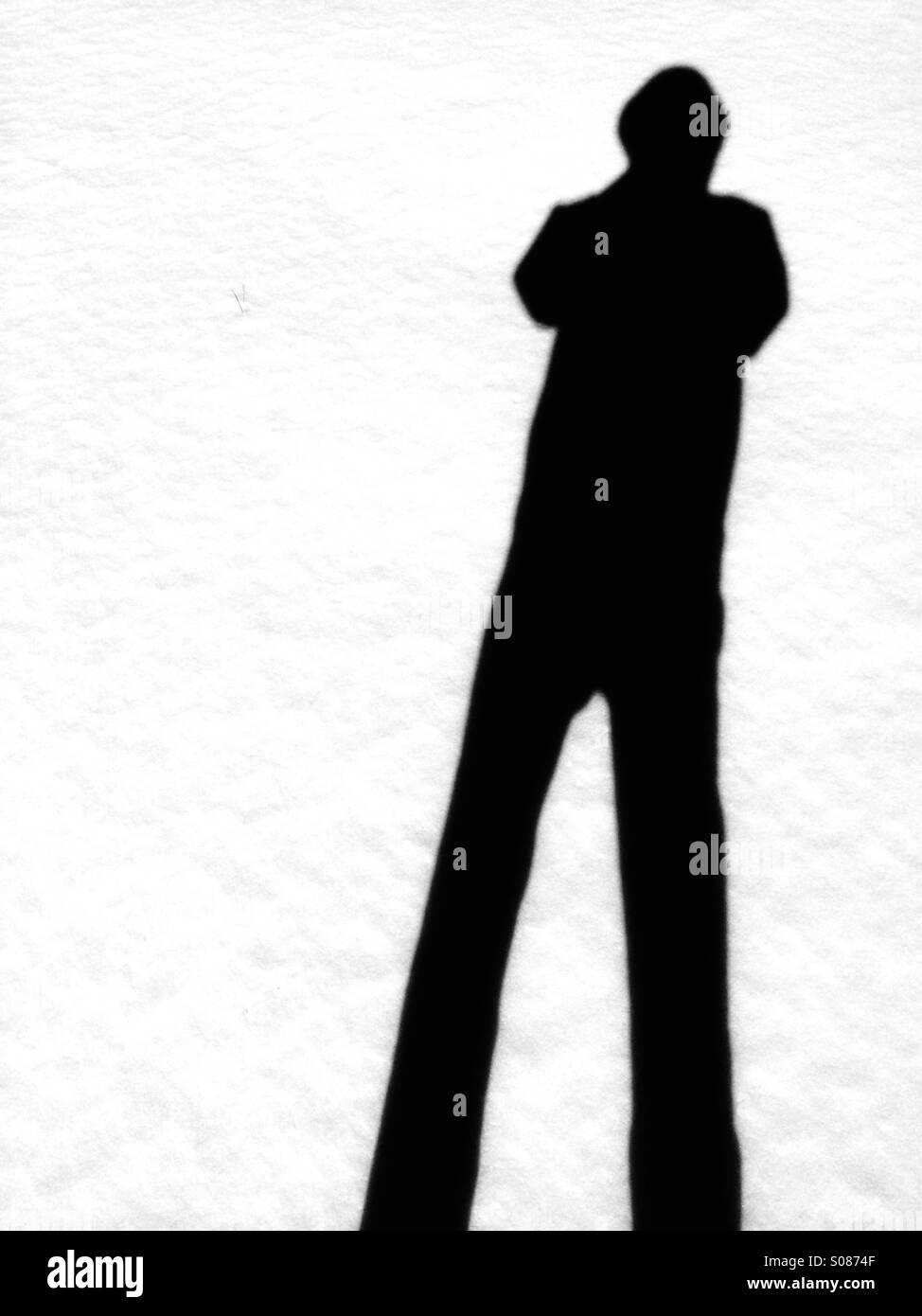 Shadow of a man against white snow. Stock Photo