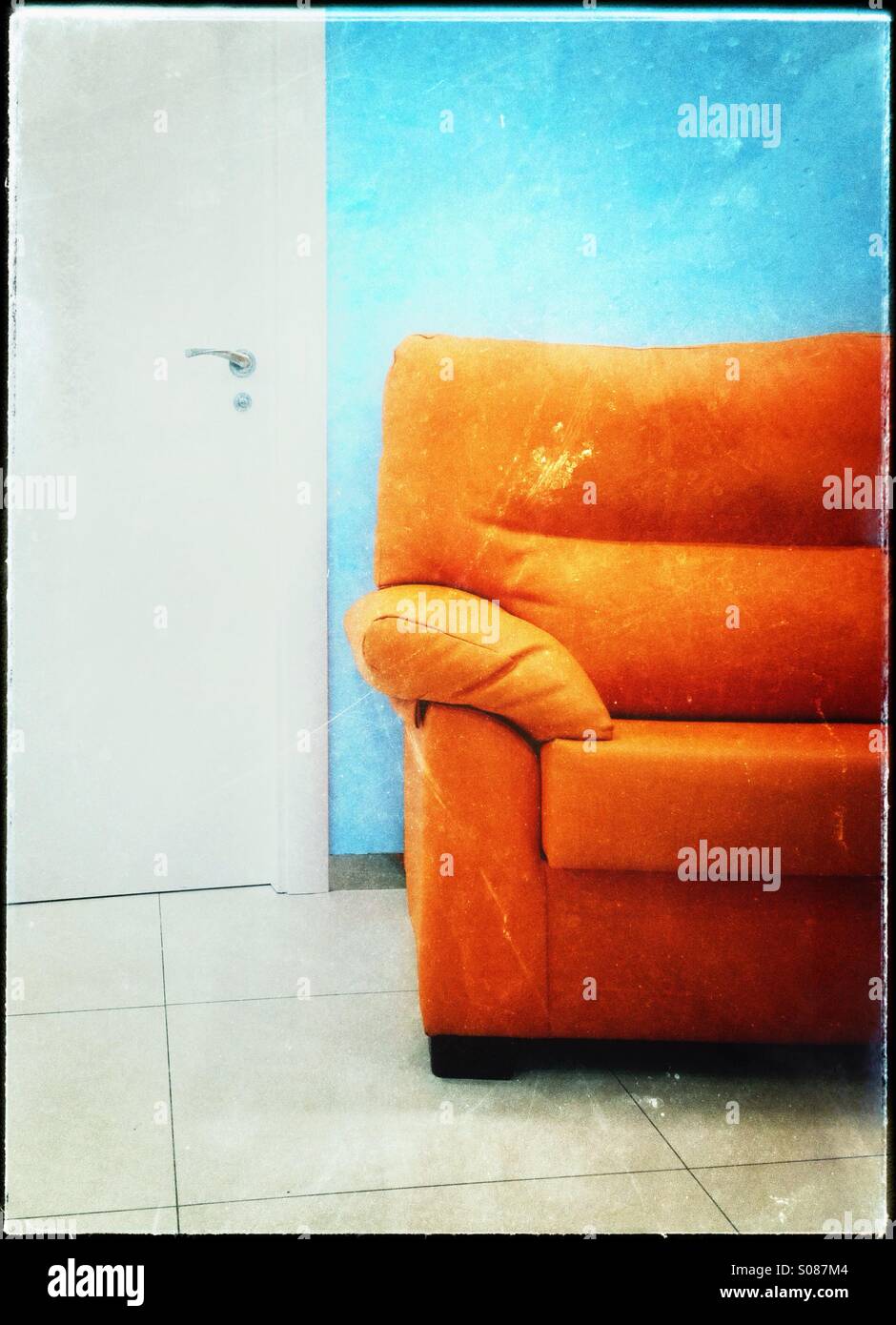 Orange sofa, blue wall, white door and floor Stock Photo Alamy