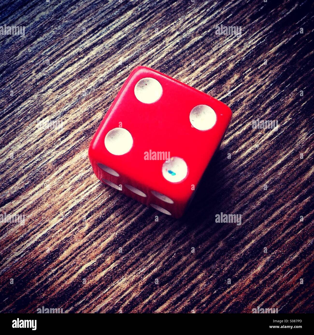 Red dice showing number 4 Stock Photo - Alamy