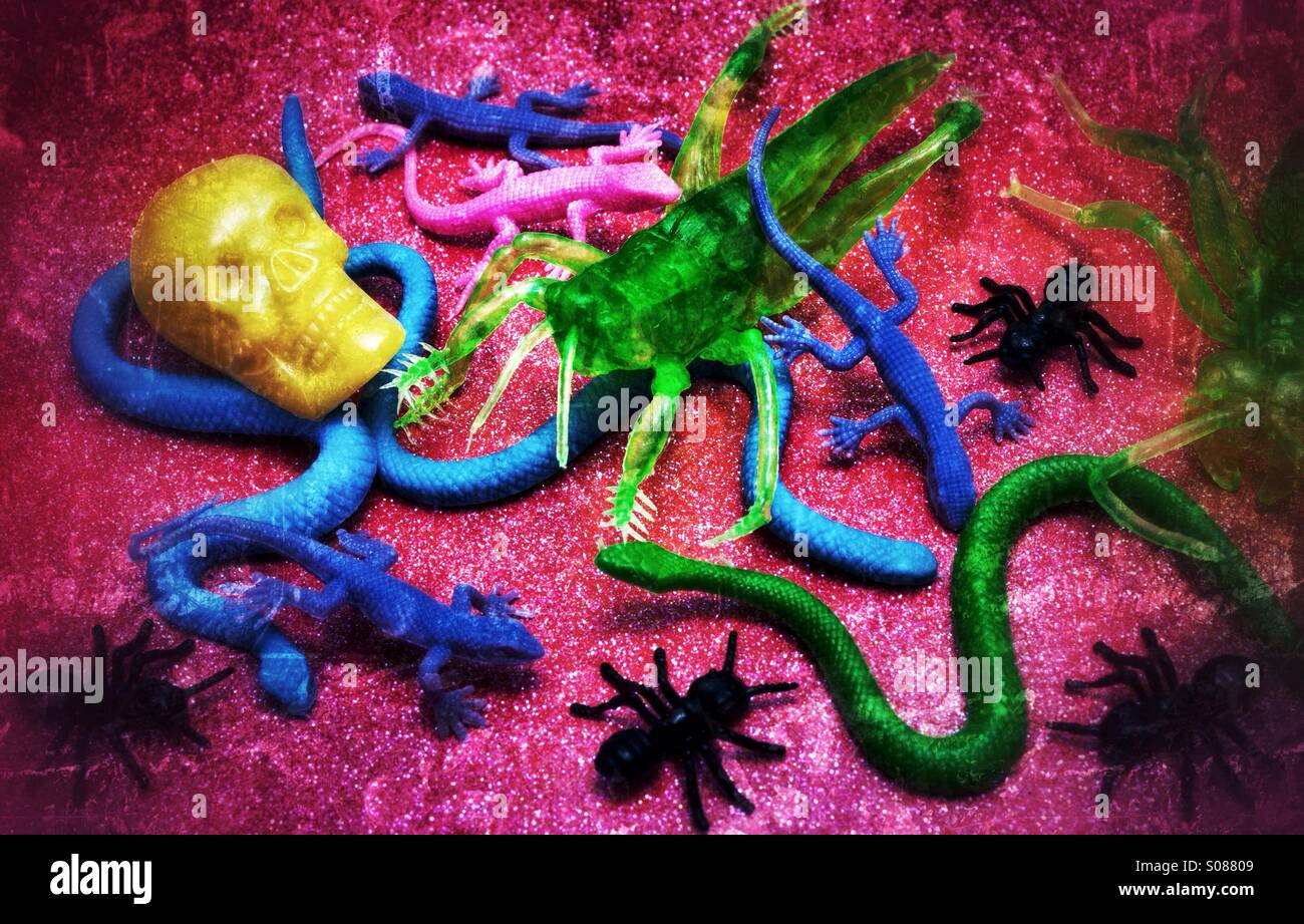 Brightly coloured plastic creepy crawlies and skull for Halloween Stock Photo