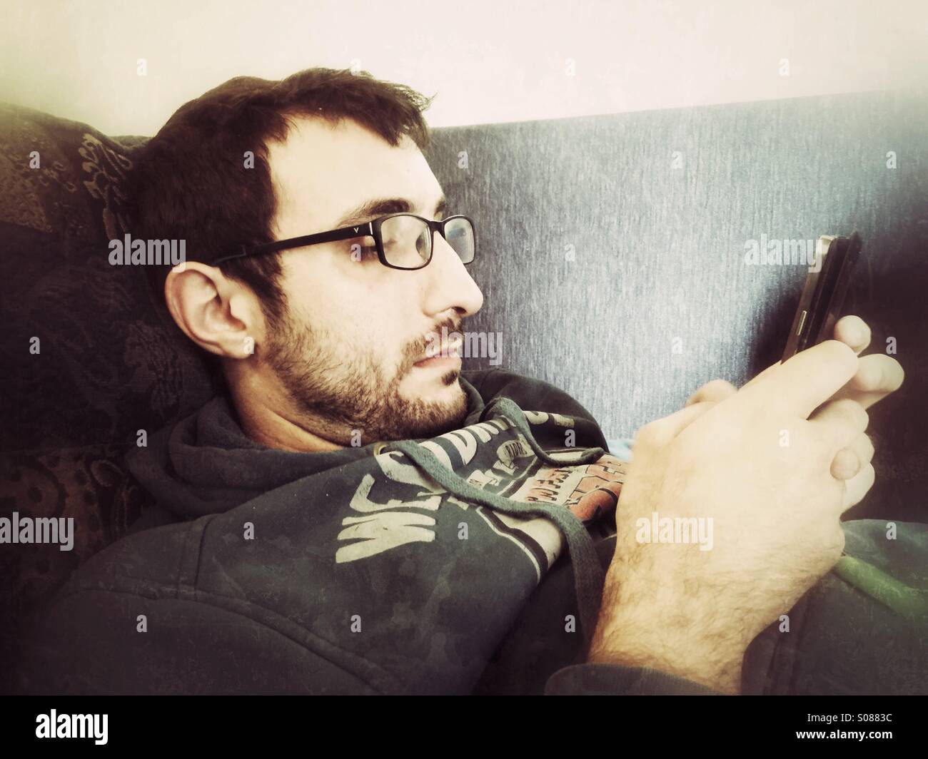 Young Man using mobile phone - Smartphone Captured Stock Image