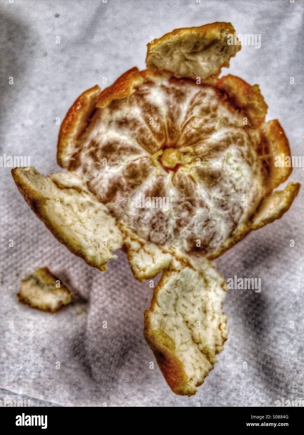 A clementine with some peeling removed. - Smartphone Captured Stock Image