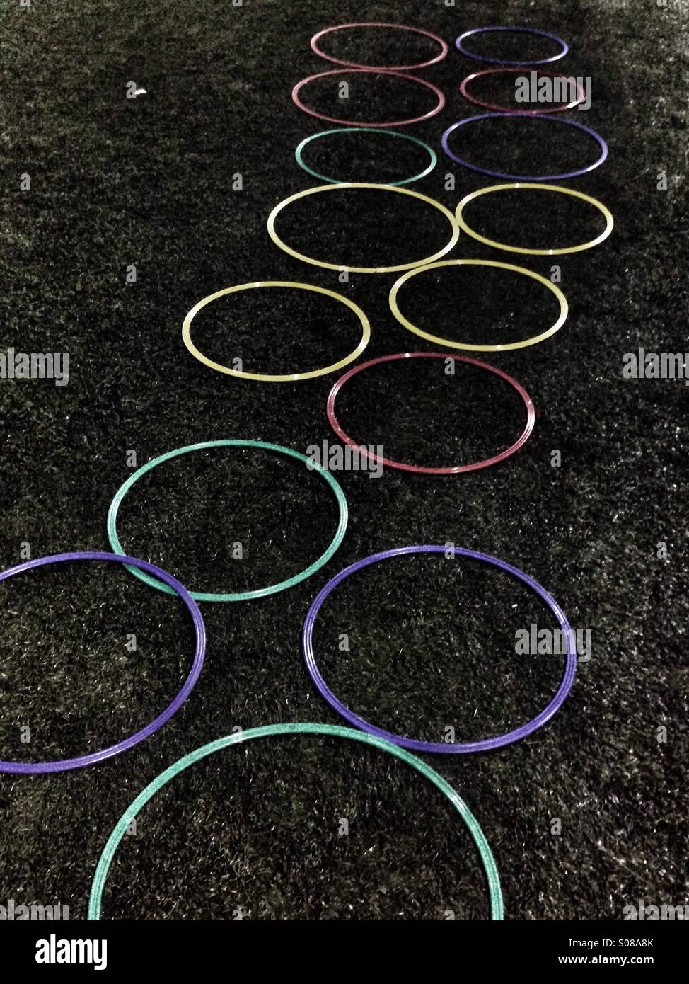 Sharp high contrast colored circles with dark green grass in the background - Smartphone Captured Stock Image
