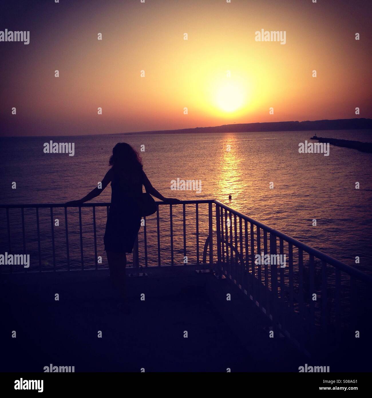 Woman looking at sunset - Smartphone Captured Stock Image