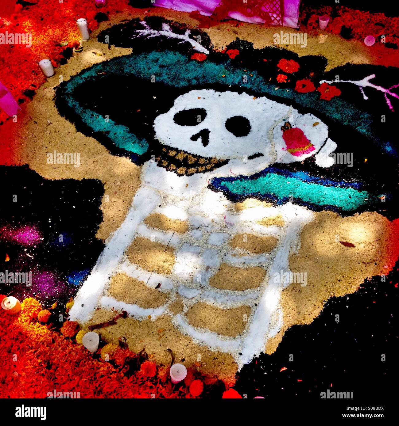 A female skeleton image made of sand, representing La Calavera Catrina, forms a part of the public altar seen on the street during the celebrations of the Day of the Dead in Morelia, Mexico. Stock Photo
