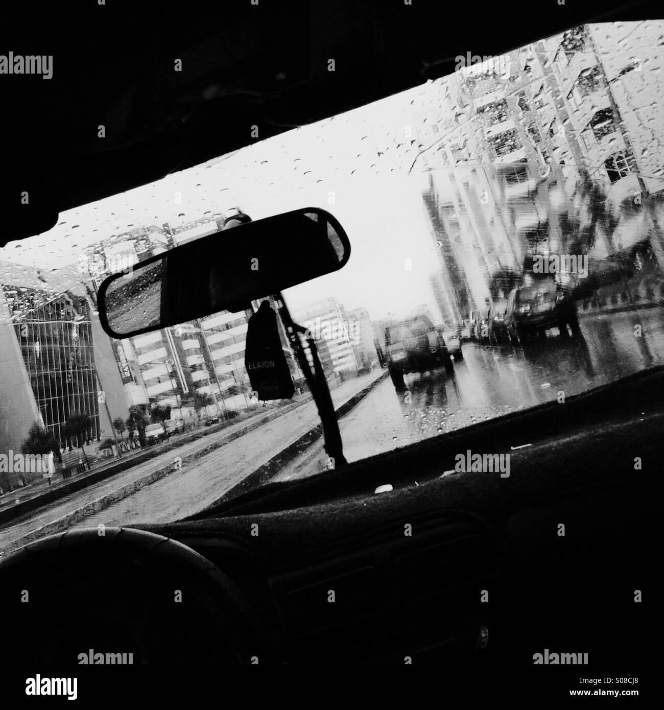 A city street with traffic seen through the taxi window during a heavy rain in Quito, Ecuador, 30 October 2013. Stock Photo