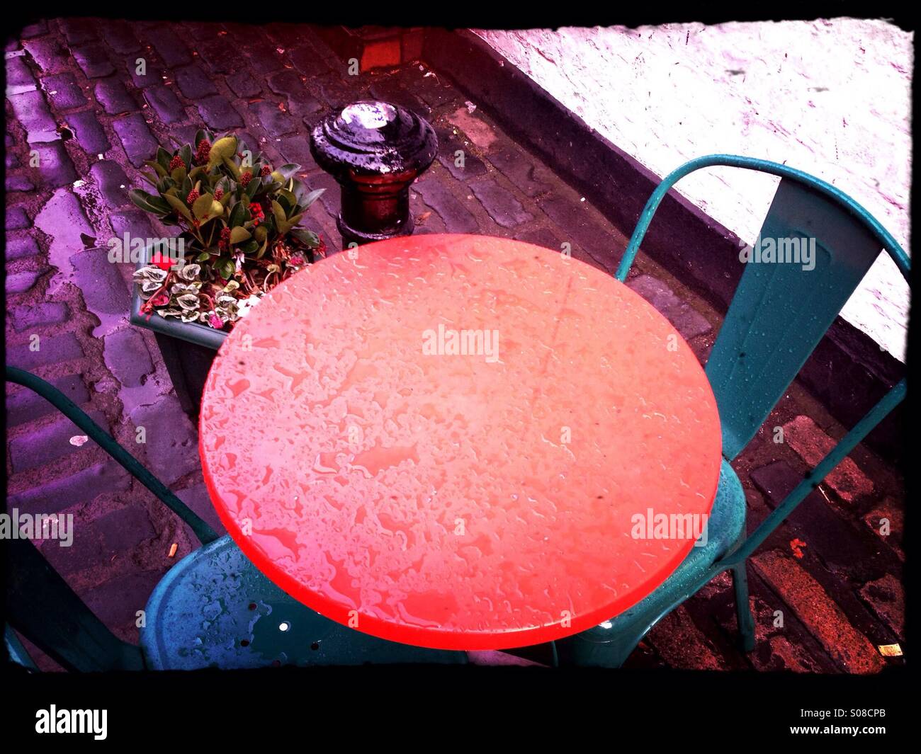 Cafe table and chairs outside in rain - Smartphone Captured Stock Image