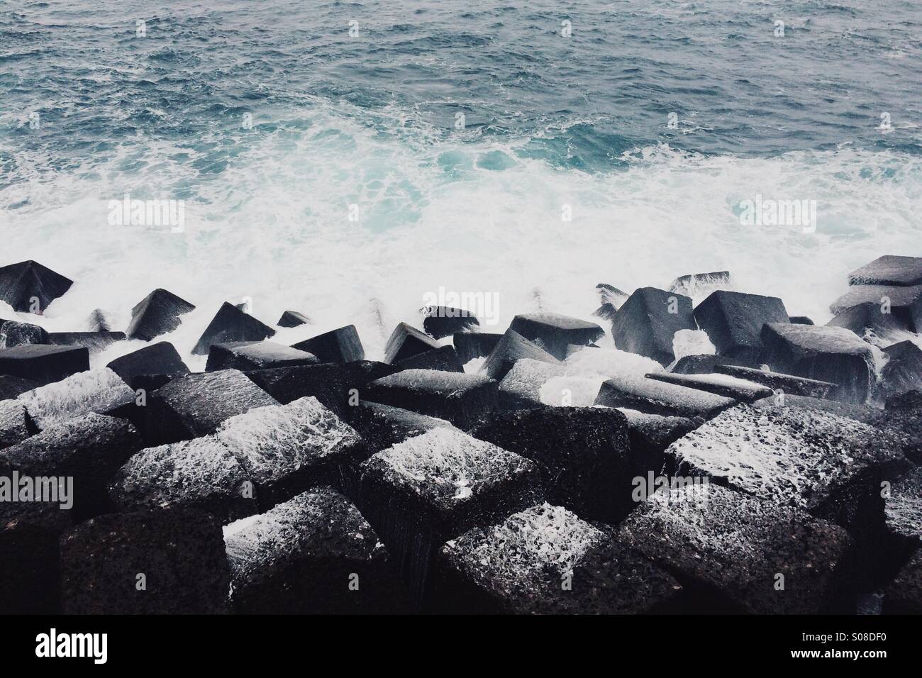 ocean spray coating cube rocks Stock Photo
